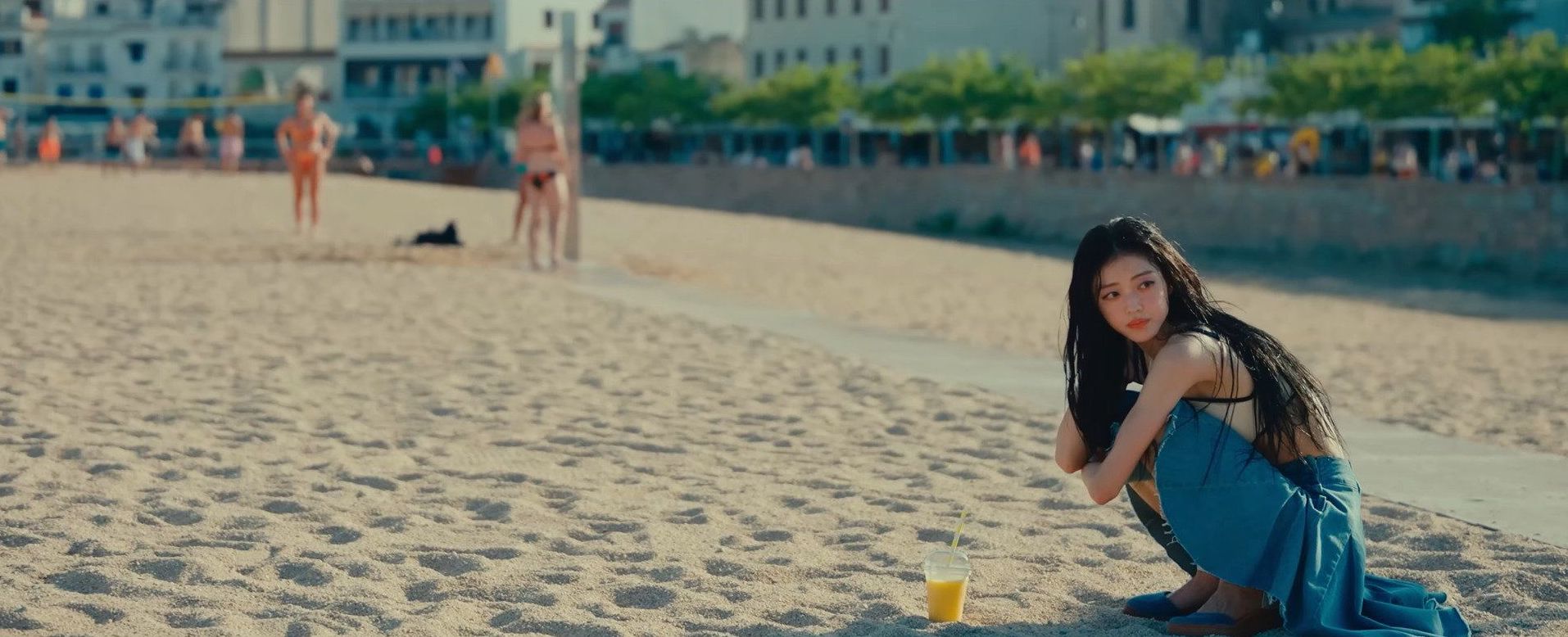 YooA walking along the Platja Gran de Tossa de Mar (Great Beach of Tossa de Mar) in the Lay Low music video (Author: SME).